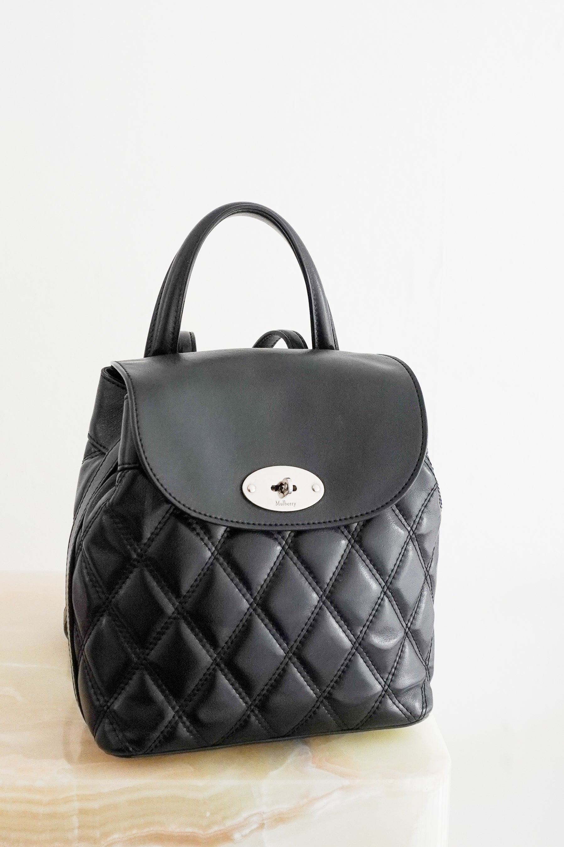 Mulberry Black Quilted Mini Backpack crafted in England from beautifully soft black leather with an all-over quilted finish and postman's lock.