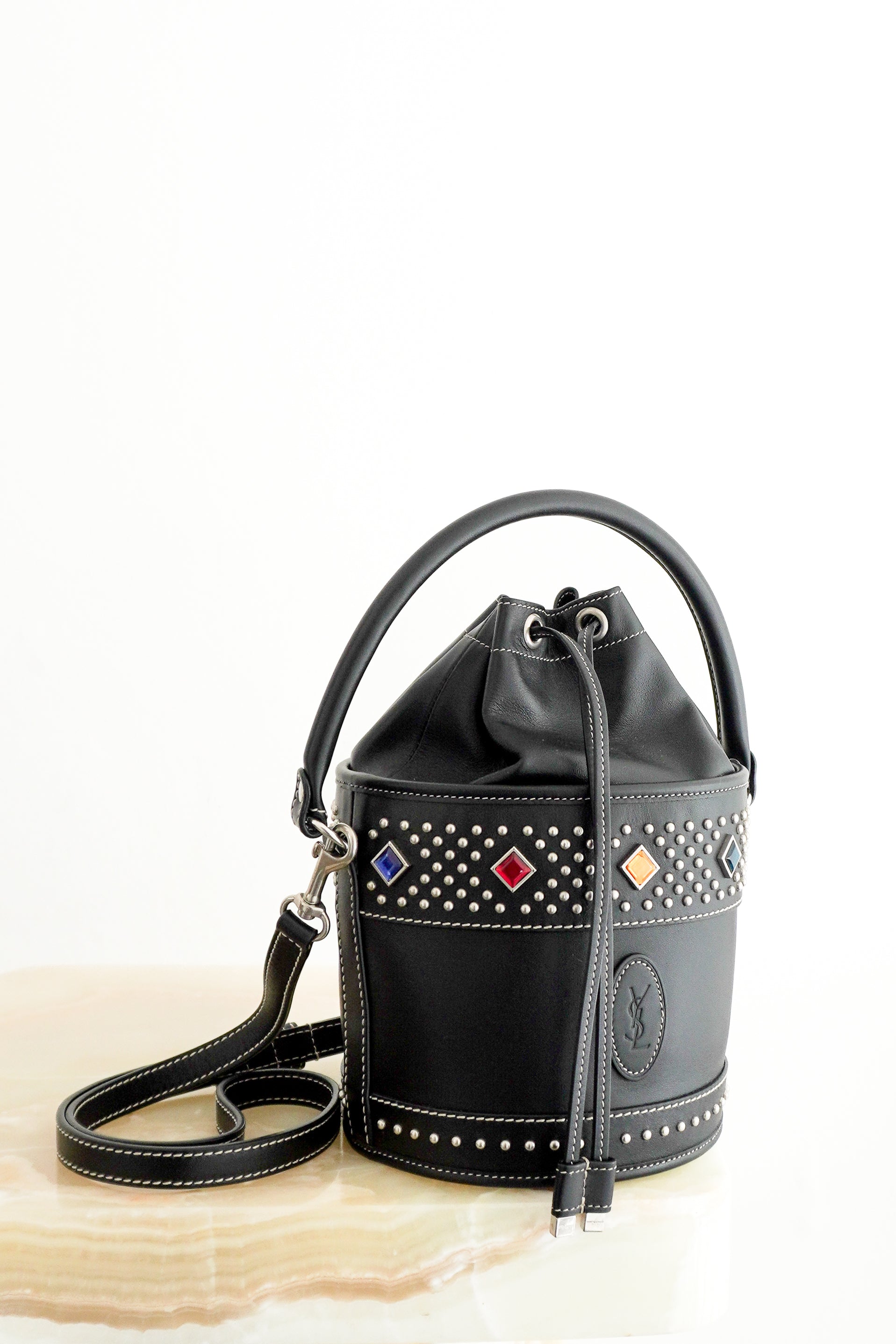 Saint Laurent Bahia Small Embellished Leather Bucket Bag in Black front photo chelsea london