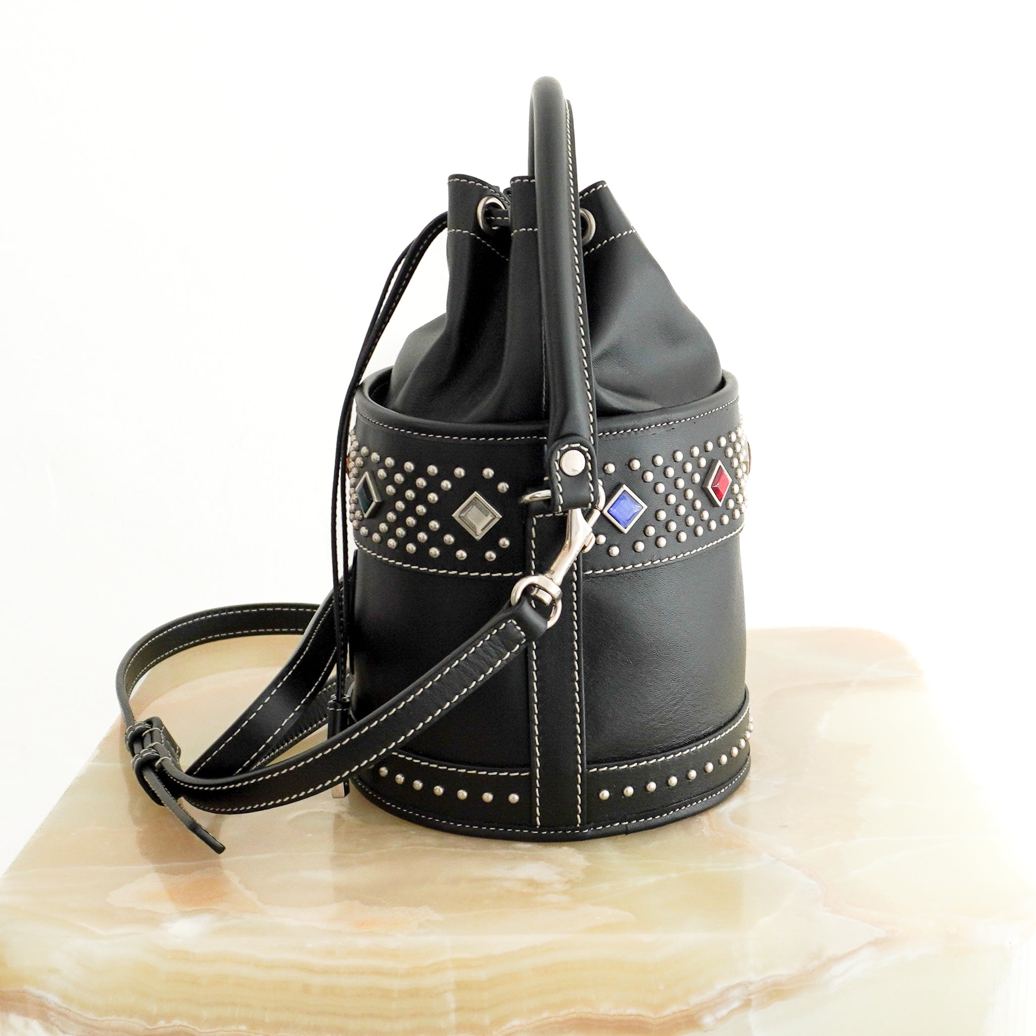 Saint Laurent Bahia Small Embellished Leather Bucket Bag in Black side photo chelsea london