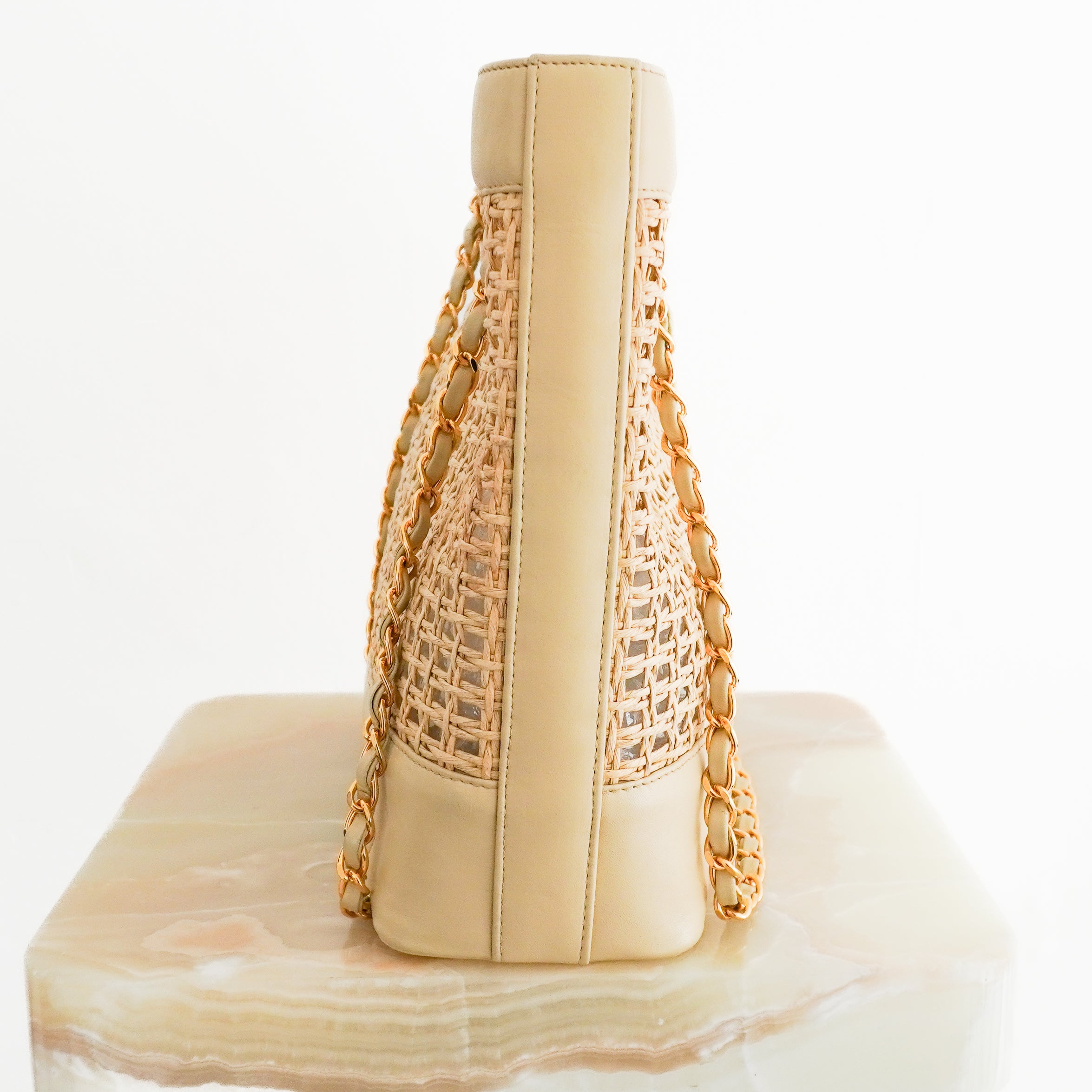 Side image of the Chanel Coco Raffia Tote
