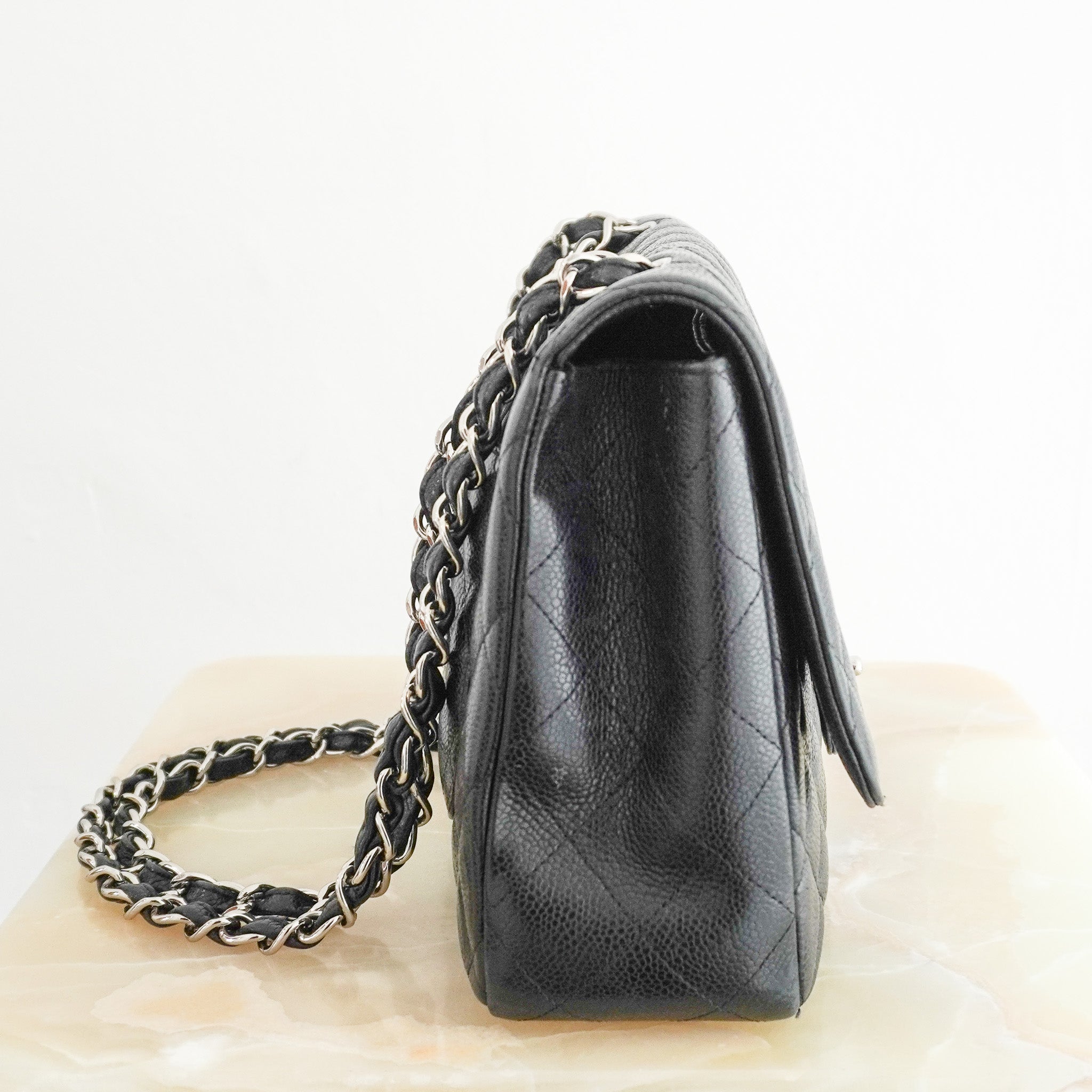 Side image of the Chanel Jumbo Classic Single Flap Bag in Black Caviar Leather 