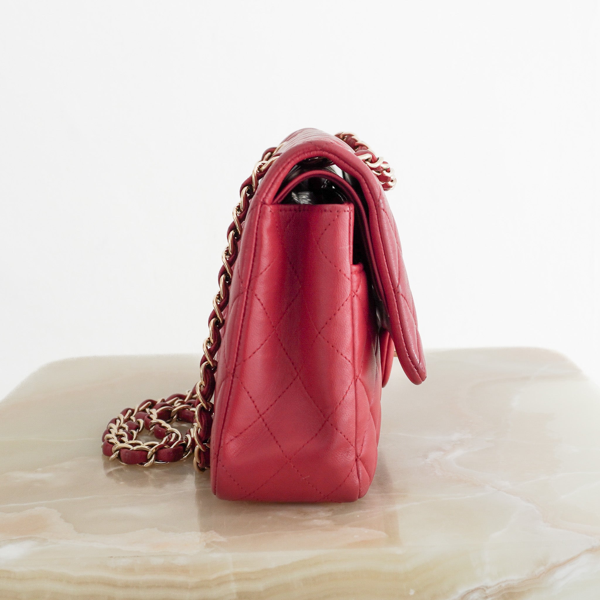 Side image of the Chanel Red Medium Classic Double Flap Bag