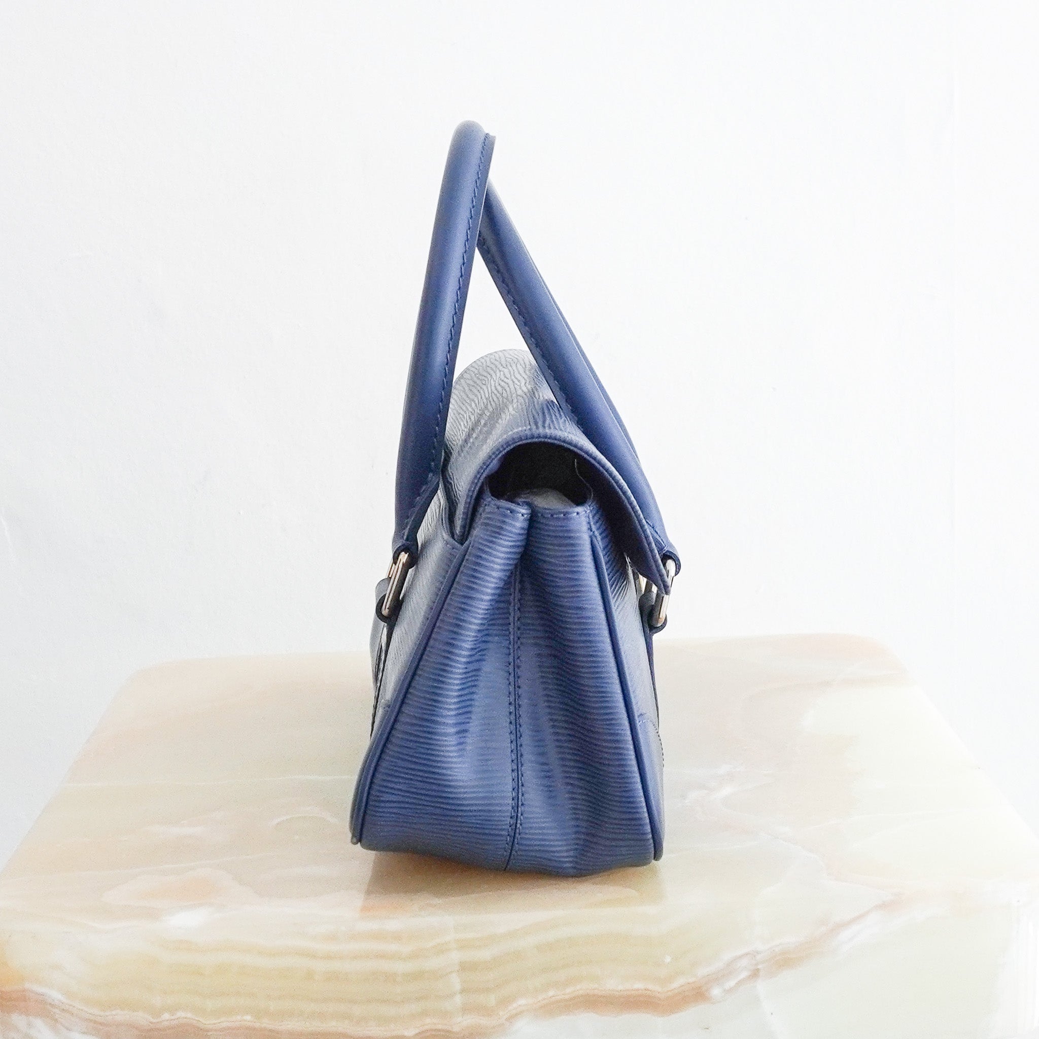 Side image of the Louis Vuitton Ségur PM Toledo Blue Epi Leather Handbag