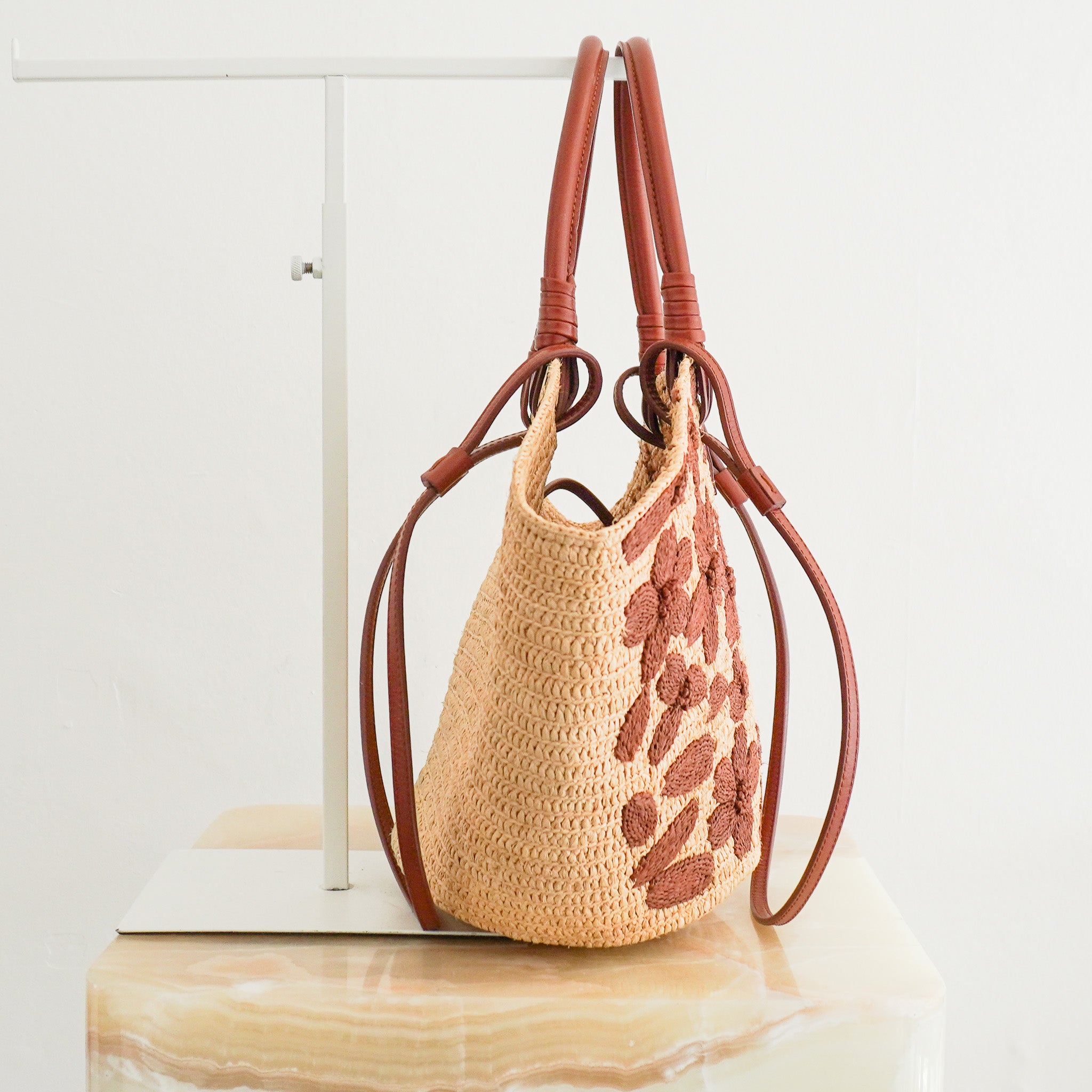 Side image of the Sezane Justie Raffia Bag with Chocolate Embroidered Flowers
