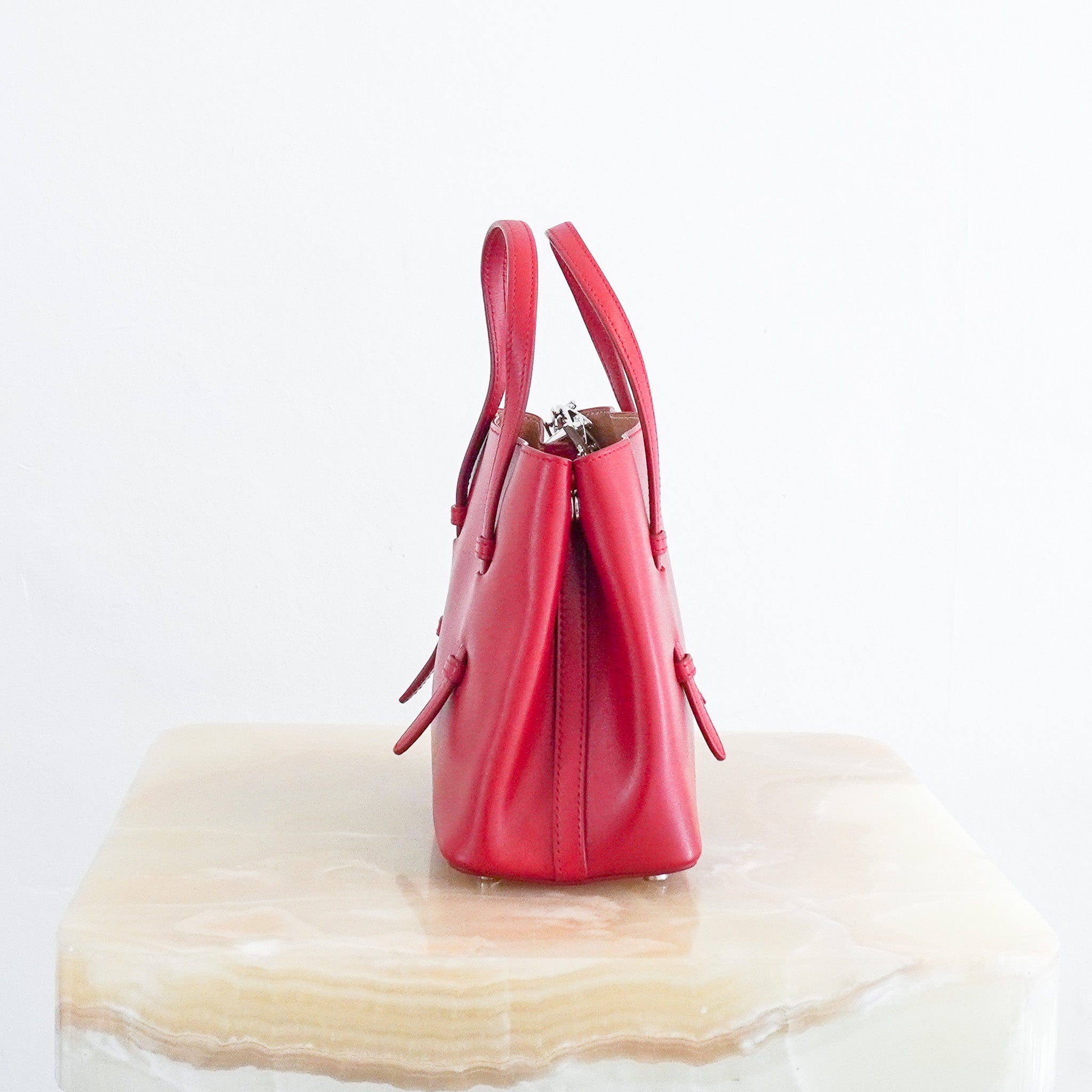 Side photo of the Alaia Mina 16 Micro Bag in Red 