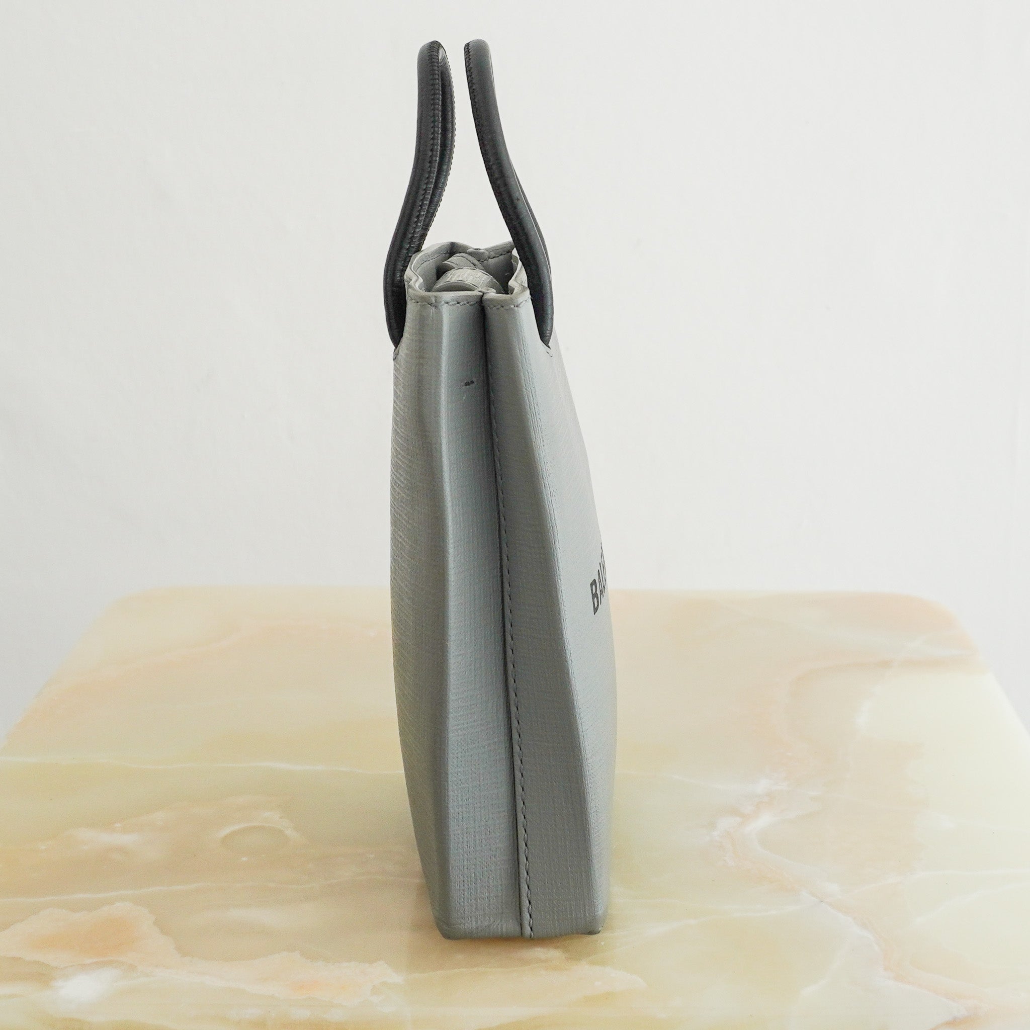 Side photo of the Balenciaga Shopping Phone Holder Bag