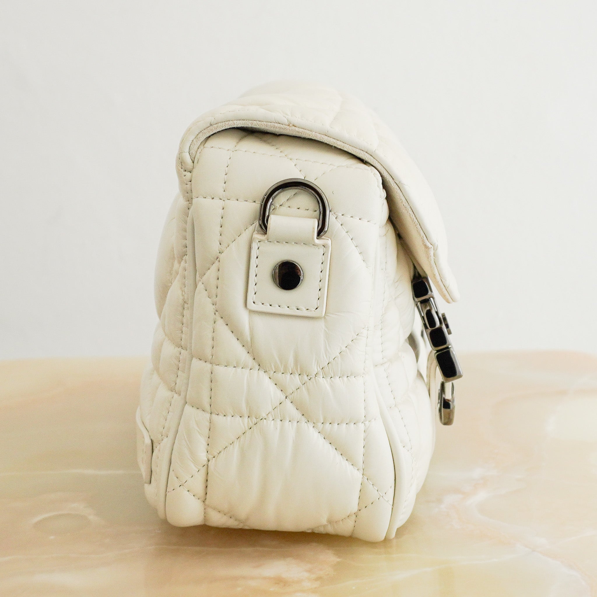 Side photo of the Christian Dior Small Diorcamp Messenger Bag Latte Macrocannage