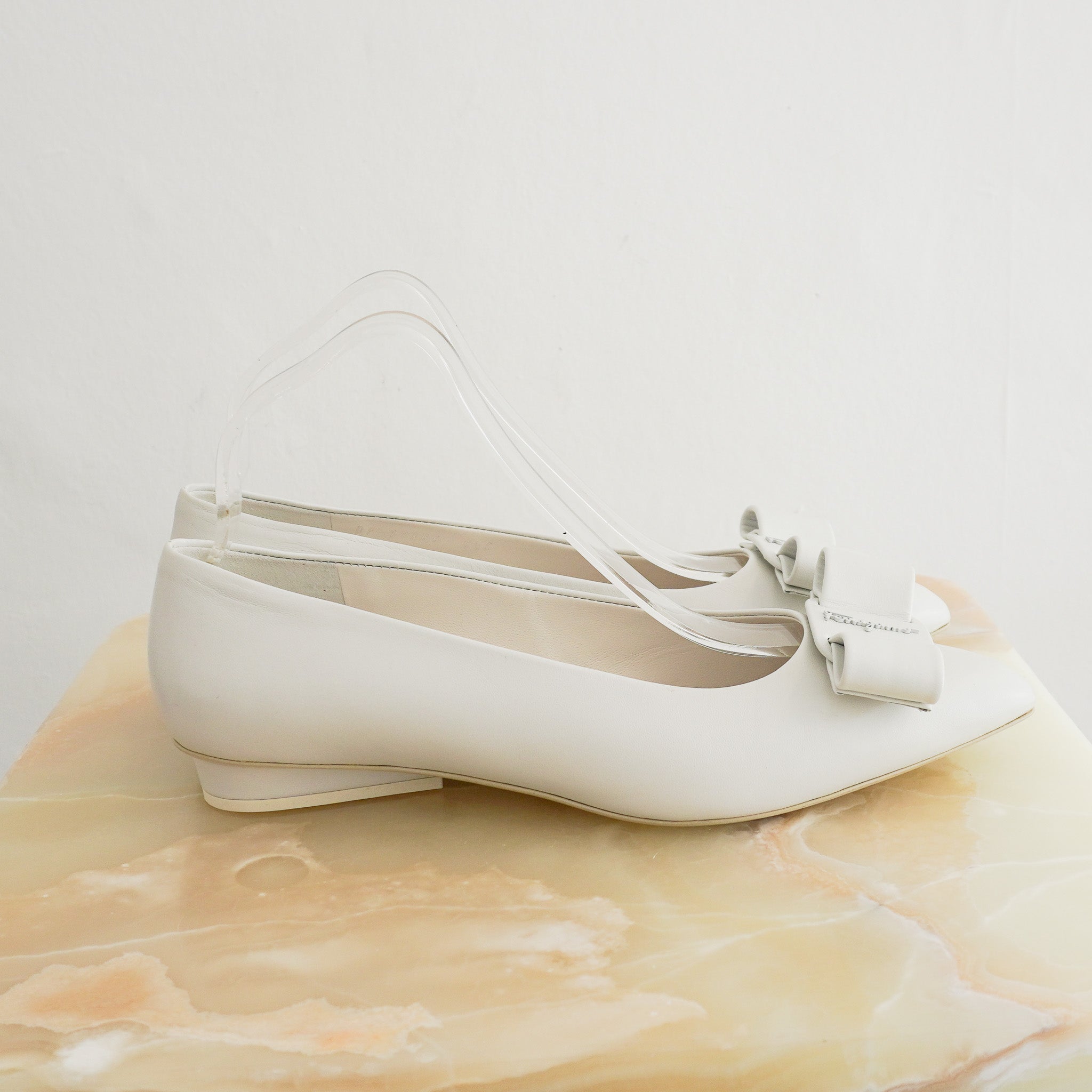 Side photo of the Salvatore Ferragamo White Pumps