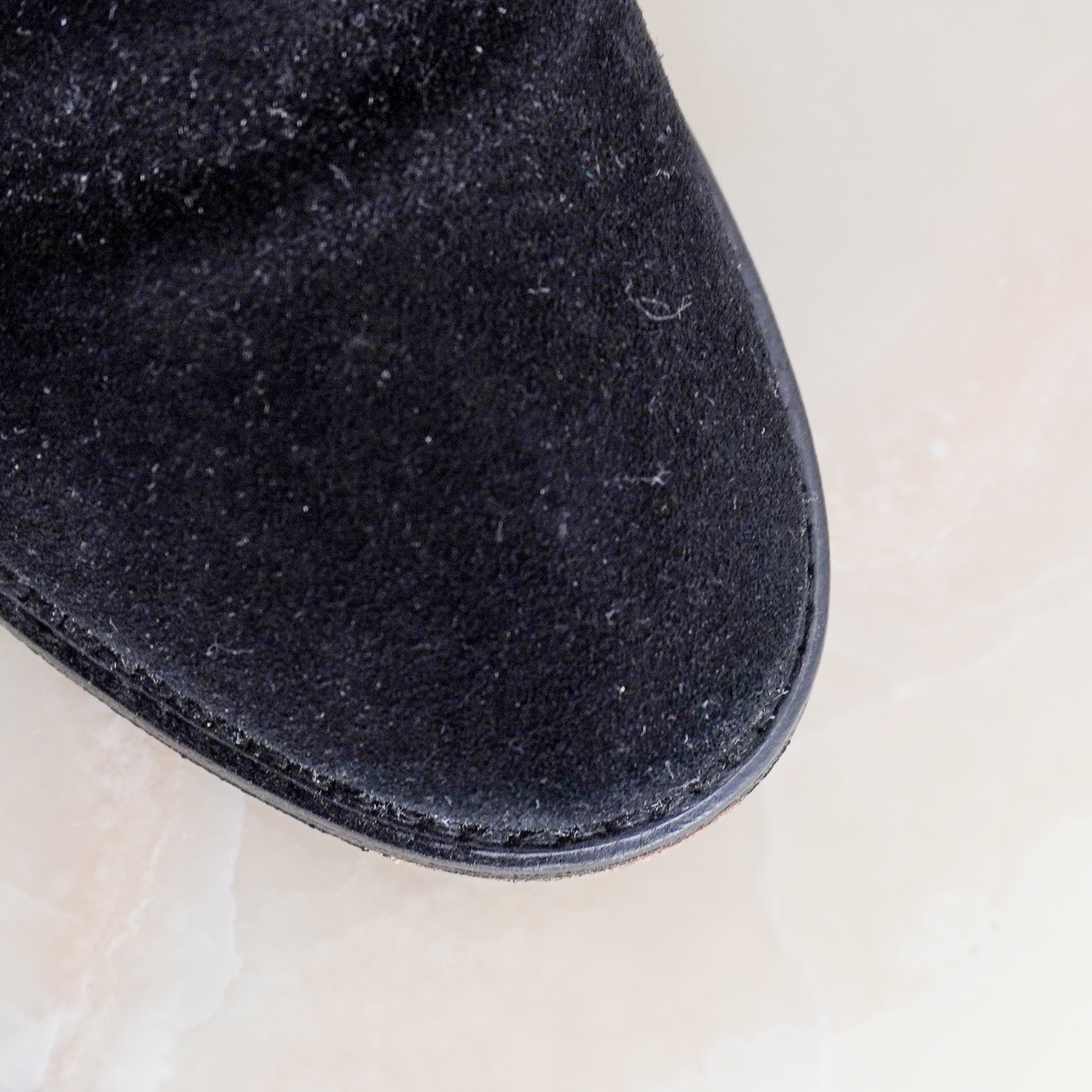 Close up image of the Isabel Marant Etoile ankle boots showing the suede exterior and stitching.